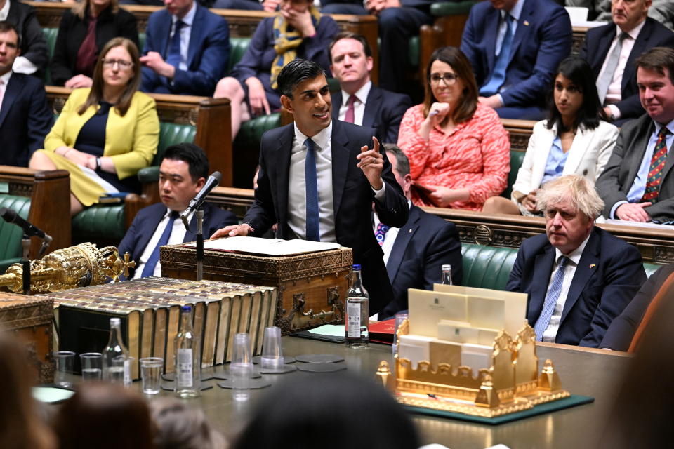 British Prime Minister Boris Johnson listens as British Chancellor of the Exchequer Rishi Sunak delivers a statement at the House of Commons in London, Britain May 26, 2022. UK Parliament/Jessica Taylor/Handout via REUTERS ATTENTION EDITORS - THIS IMAGE HAS BEEN SUPPLIED BY A THIRD PARTY. MANDATORY CREDIT. IMAGE MUST NOT BE ALTERED.