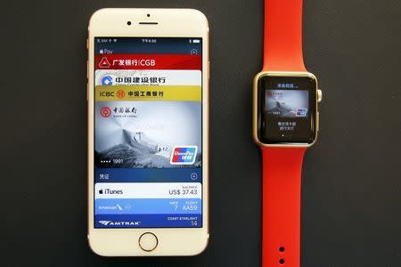 The Apple iPhone and Apple Watch are arranged to be photographed after they were used to demonstrate to reporters how to pay using the Apple Pay service at an Apple store in Beijing, China, February 17, 2016. REUTERS/Damir Sagolj