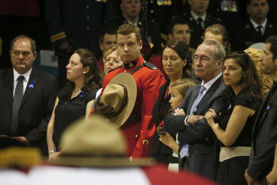 Family members attend the regimental funeral for three Royal Canadian Mounted Police officers who were killed last week in Moncton