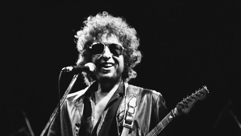 American singer Bob Dylan smiles as he performs during his show at the Colombes Olympic stadium in Colombes, France, on June 24, 1981.