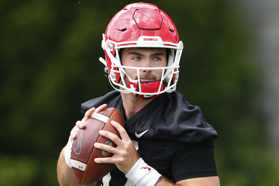 FILE - In this Aug. 2, 2019, file photo, Georgia quarterback Jake Fromm throws a pass during the team's first scheduled NCAA college football practice, in Athens, Ga. Fromm is breaking in an almost completely new corps of wide receivers after losing the Bulldogs' top five leaders in catches from 2018.(AP Photo/John Bazemore, File)