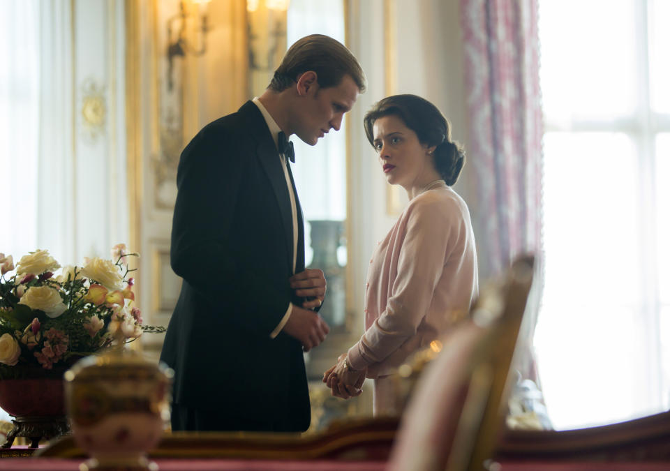 In this image released by Netflix, Claire Foy as Queen Elizabeth II, right, and Matt Smith as Prince Philip in a scene from "The Crown." Britain's Prince Philip stood loyally behind behind Queen Elizabeth, as his character does on Netflix's “The Crown.” But how closely does the TV character match the real prince, who died Friday, April 9, 2021 at 99? Philip is depicted as a man of action in “The Crown,” and he served with distinction in the navy in World War II. He was also an avid yachtsman and polo player. (Robert Viglasky/Netflix via AP)
