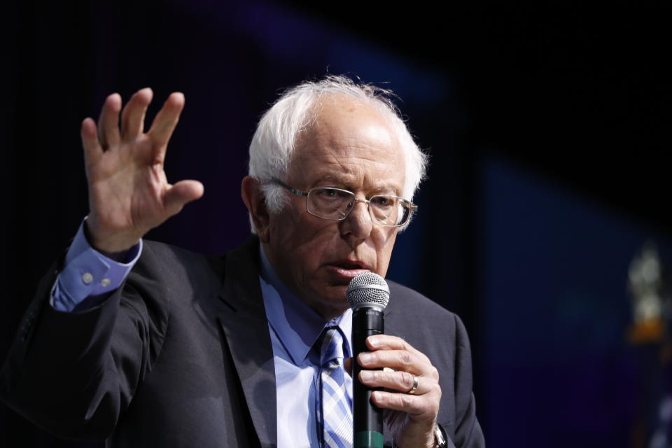 Democratic presidential candidate Sen. Bernie Sanders, I-Vt., speaks at the J Street National Conference, with the hosts of "Pod Save the World," Tommy Vietor, left, and Ben Rhodes, Monday, Oct. 28, 2019, in Washington. (AP Photo/Jacquelyn Martin)