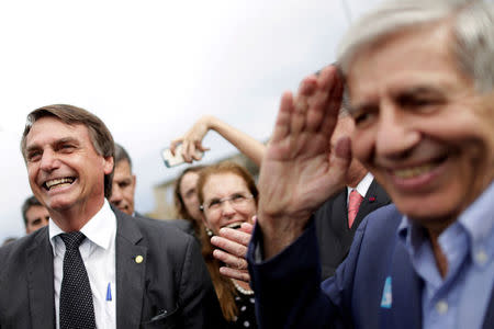 FILE PHOTO: Federal deputy Jair Bolsonaro, a pre-candidate for Brazil's presidential elections speaks with Augusto Heleno Pereira, retired General of the Brazilian Army, during a protest against former Brazilian president Luiz Inacio Lula da Silva while the Supreme Court issues its final decision about his habeas corpus plea, in Brasilia, Brazil, April 4, 2018. REUTERS/Ueslei Marcelino/File photo