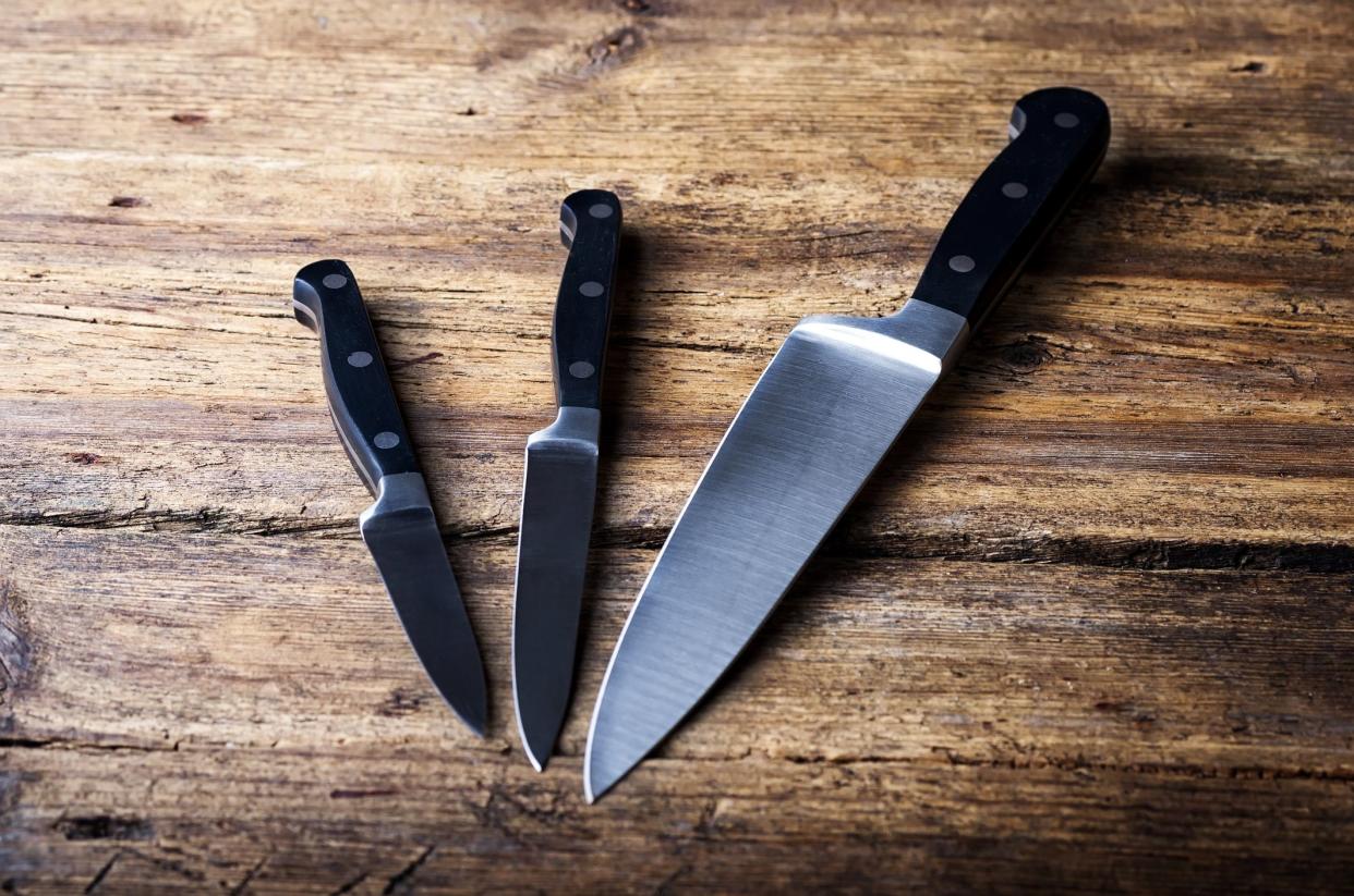 Knife on rustic kitchen table with copy space