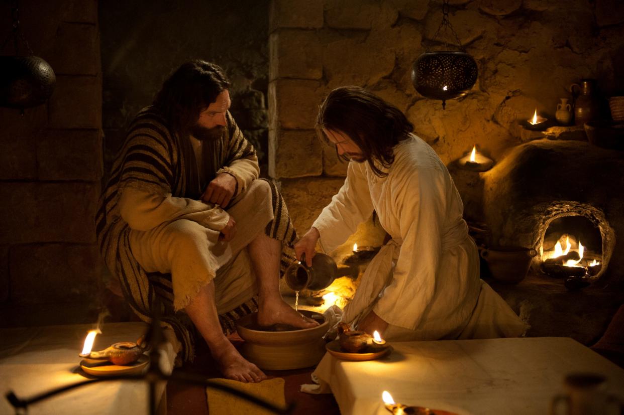 Jesus washes Peter's feet while at the Last Supper with the Apostles in this image from the Bible Videos series.