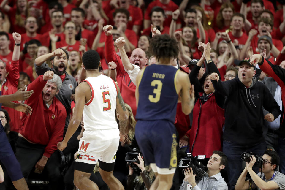 Fans react after Maryland guard Eric Ayala (5) dunked as Notre Dame guard Prentiss Hubb (3) looks on during the first half of an NCAA college basketball game, Wednesday, Dec. 4, 2019, in College Park, Md. (AP Photo/Julio Cortez)