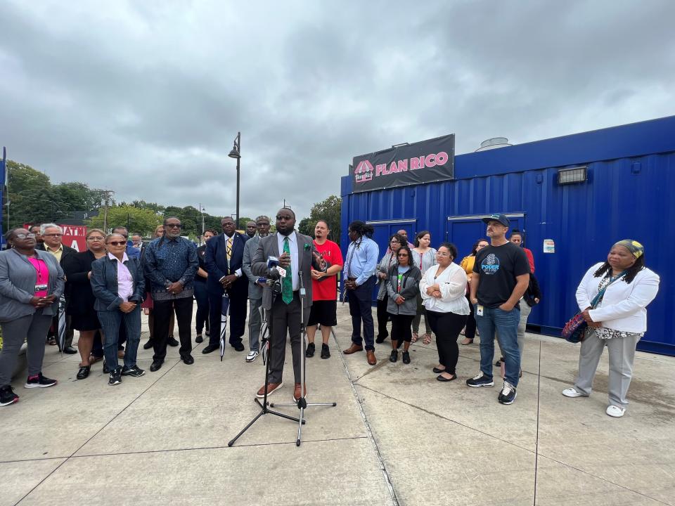 Flanked by community elders and violence prevention workers, Anthony Hall (center) addresses a spate of shootings that killed three and injured several others between Aug. 3 and Aug. 5, 2023.