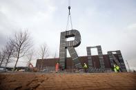 In this handout image supplied by the Olympic Delivery Authority, workers carryout the installation of artist Monica Bonvicini's 'RUN' sculpture in the plaza of the London 2012 Handball Arena at the Olympic Park on January 12, 2012 in London, England. ( Olympic Delivery Authority via Getty Images)