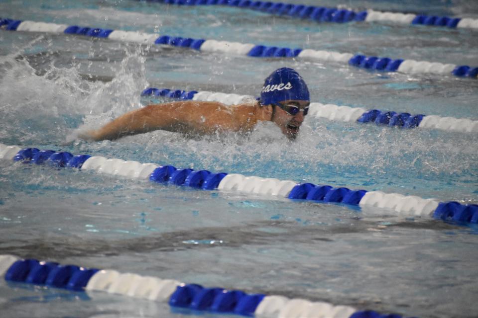 Indian Creek swimmer Evan Dennis competes in the 100-yard butterfly during sectional preliminaries at Franklin Community High School on Feb. 17, 2022.