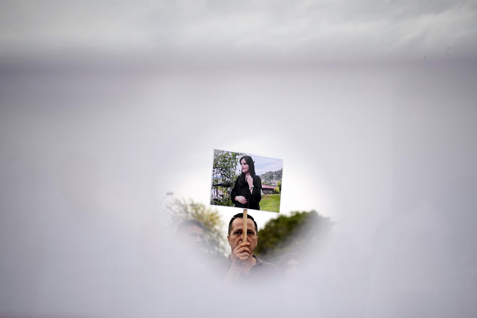 FILE - People protest against the death of Iranian woman Mahsa Amini in Bucharest, Romania, Saturday, Oct. 1, 2022. As anti-government protests roil cities and towns in Iran for a fourth week, sparked by the death of the 22-year-old woman detained by Iran's morality police, tens of thousands of Iranians living abroad have marched on the streets of Europe, North America and beyond in support of what many believe to be a watershed moment for their home country. (AP Photo/Andreea Alexandru, File)