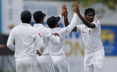 Cricket - Sri Lanka v India - First Test Match - Galle, Sri Lanka - July 26, 2017 - Sri Lanka's Nuwan Pradeep celebrates with his teammates after taking the wicket of India's cricketer Abhinav Mukund (not pictured). REUTERS/Dinuka Liyanawatte