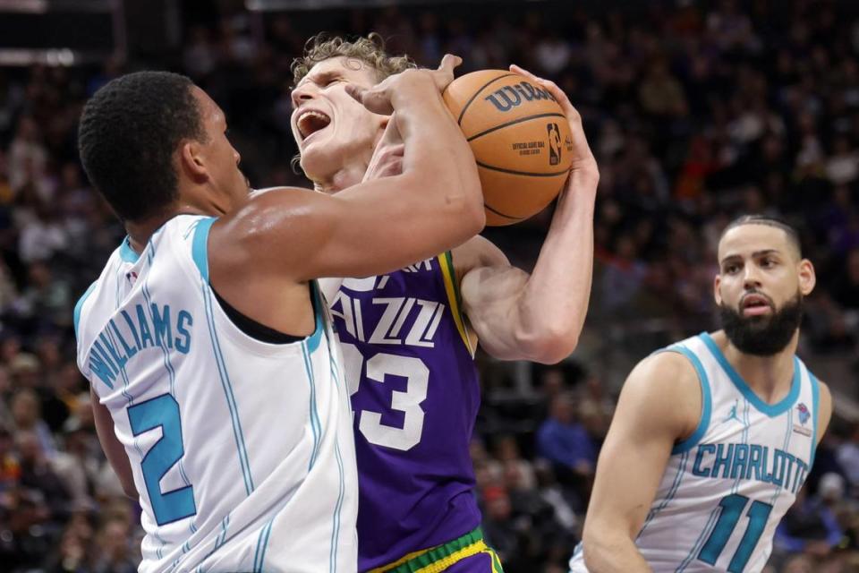 Utah Jazz forward Lauri Markkanen (23) is fouled by Charlotte Hornets forward Grant Williams (2) during the second quarter at Delta Center.