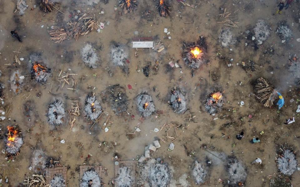 A mass cremation of victims who died from coronavirus, at a crematorium ground in New Delhi, India - REUTERS/Danish Siddiqui 