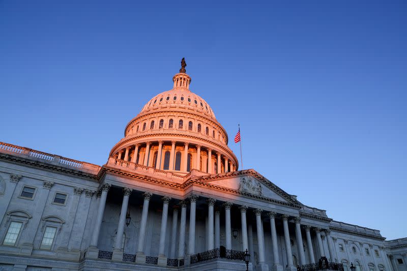 FILE PHOTO: The sun rises on the U.S. Capitol dome before Joe Biden's presidential inauguration in Washington
