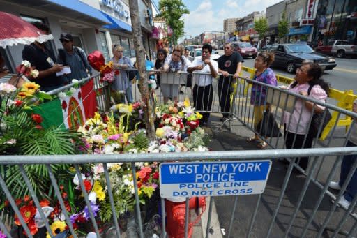 People view a knot in a tree that people say looks like Our Lady of Guadalupe on July 24, 2012 on Bergenline Avenue in West New York, New Jersey. The Catholic Church has distanced itself from the supposed miracle and there's no shortage of scoffers in West New York, a tough place with a high Latin American immigrant population