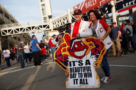 Fans of the American League baseball team Cleveland Indians pose for pictures outside Progressive Field before Game 6 of Major League Baseball World Series game against the National League baseball team Chicago Cubs in Cleveland, Ohio U.S., November 1, 2016. REUTERS/Shannon Stapleton