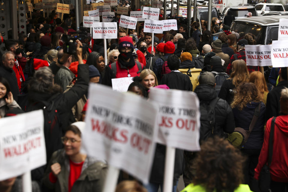 Hundreds of New York Times journalists and other staff picket outside the Times' office after walking off the job for 24 hours, frustrated by contract negotiations that have dragged on for months in the newspaper's biggest labor dispute in more than 40 years, Thursday, Dec. 8, 2022, in New York. (AP Photo/Julia Nikhinson)