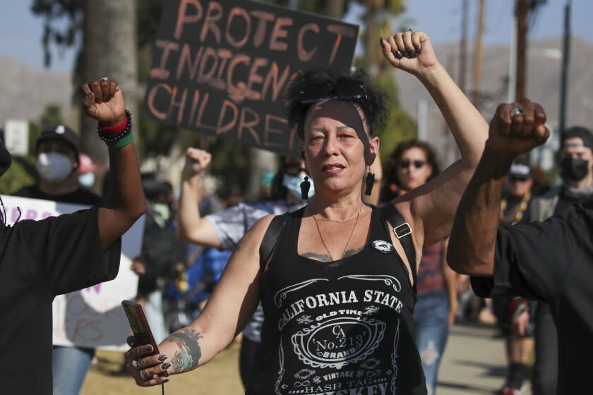 Riverside, CA - October 21: Denise Maupin and other community members protest outside John W. North High School in Riverside after a viral video showed a math teacher wearing a faux headdress and mimicking Native Americans during class. (Irfan Khan / Los Angeles Times)