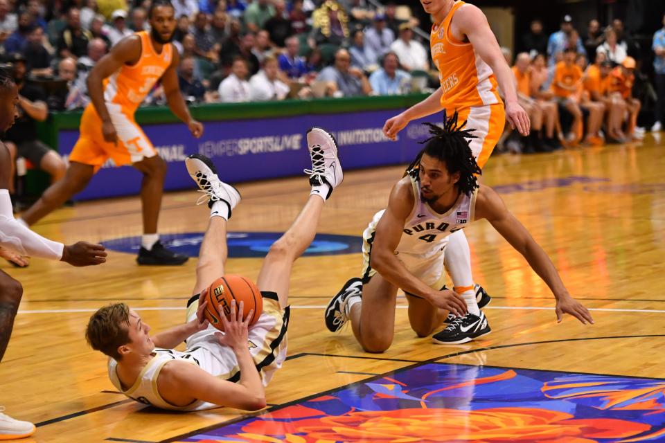 Nov 21, 2023; Honolulu, HI, USA; Purdue Boilermakers guard Fletcher Loyer (2) and Trey Kaufman-Renn (4) fight for the ball during the first half against the Tennessee Volunteers at SimpliFi Arena at Stan Sheriff Center. Mandatory Credit: Steven Erler-USA TODAY Sports