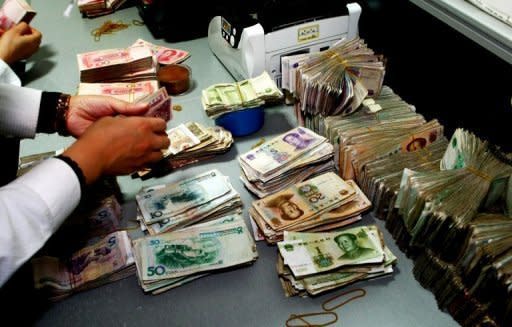 A clerk counts stacks of Chinese notes at a bank in Suining, southwest China's Sichuan province, in December 2011. China's Premier Wen Jiabao has called for the break-up of a banking "monopoly" on lending that has squeezed private businesses as the global economy slows, state media reported