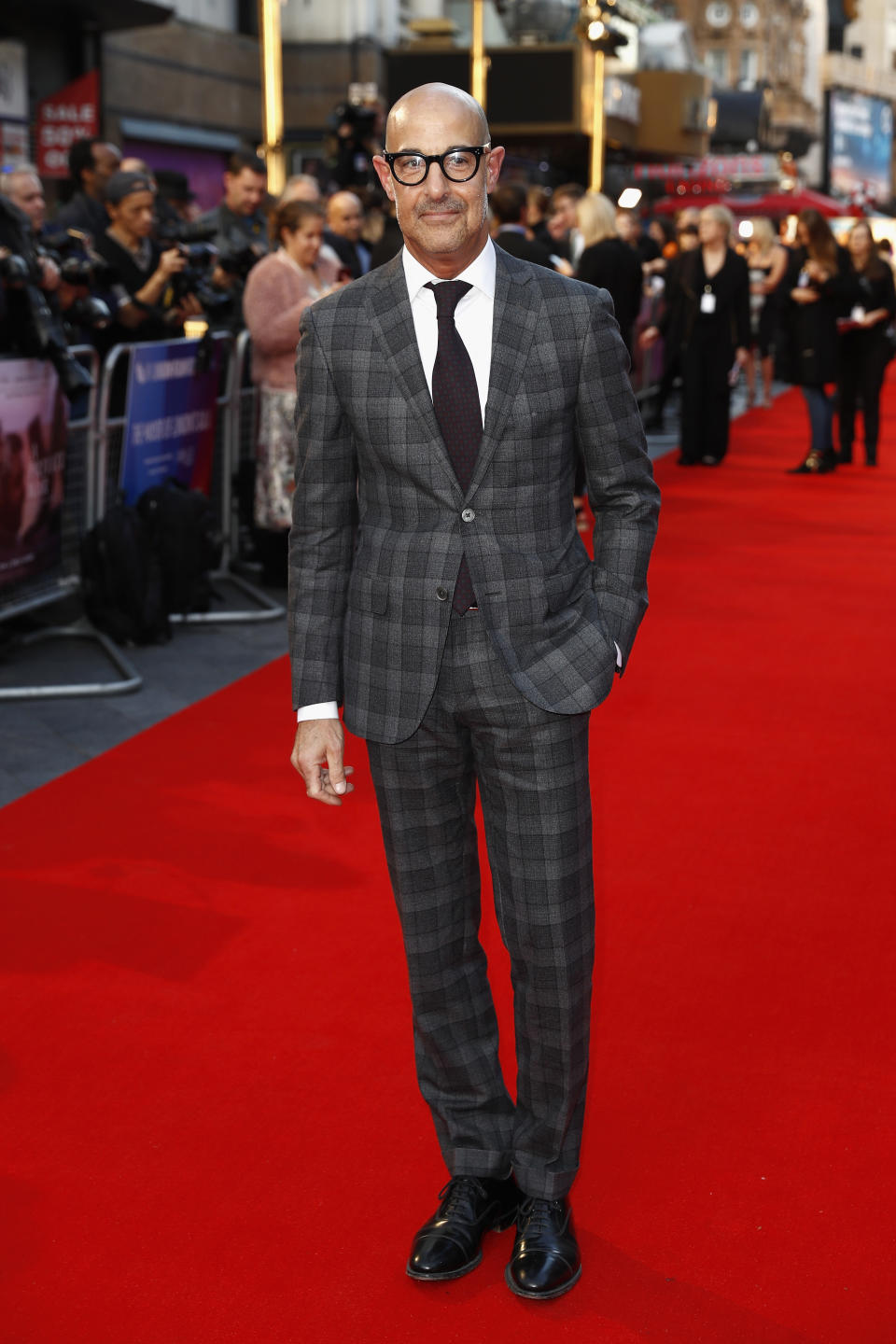 <p>Stanley cut a sharp figure in a grey, check suit by Corneliani for the European premiere of ‘A Private War’. <em>[Photo: Getty]</em> </p>