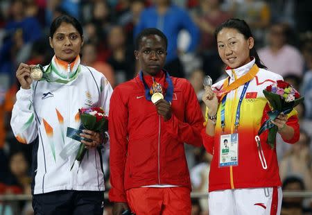 Bahrain's Ruth Jebet (C) poses with her gold medal for the women's 3,000m steeplechase at the Incheon Asiad Main Stadium during the 17th Asian Games September 28, 2014. REUTERS/Jason Reed