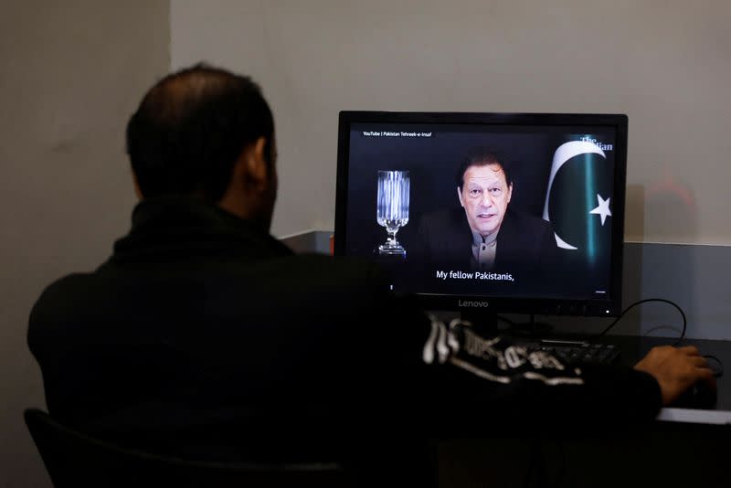 A man views a computer screen displaying the AI-crafted speech of former Prime Minister Imran Khan, to call for votes ahead of the general elections in Karachi