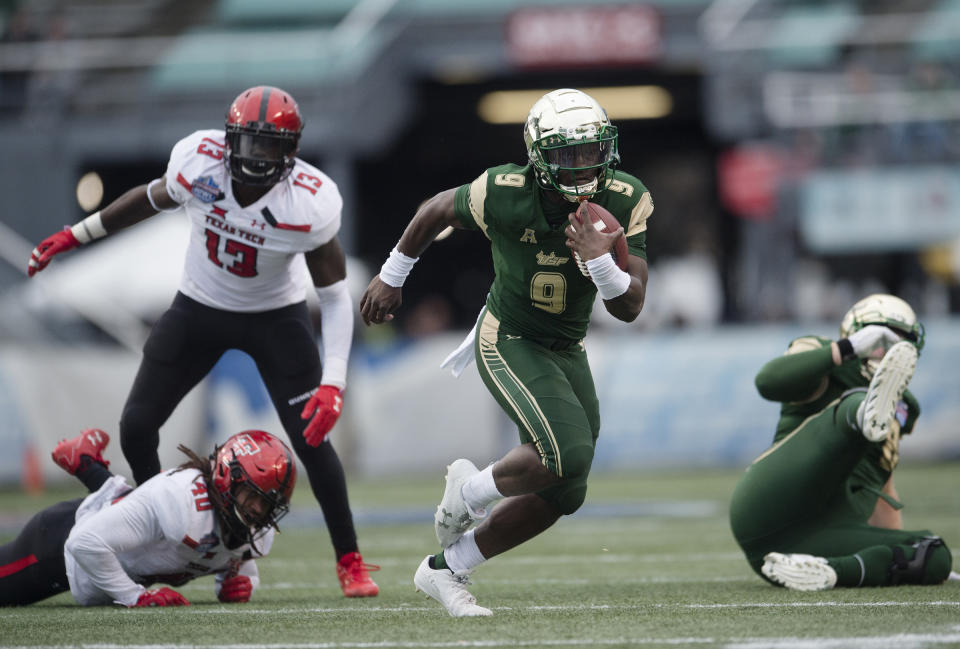 South Florida quarterback Quinton Flowers (C) runs downfield during the first half the Birmingham Bowl NCAA college football game, Saturday, Dec. 23, 2017 in Birmingham, Ala. (AP Photo/Albert Cesare)