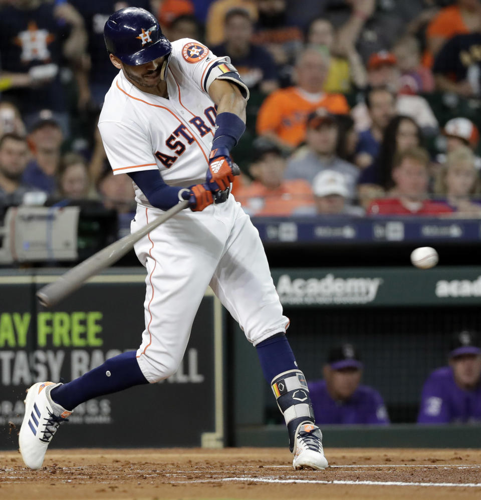 Houston Astros' Carlos Correa hits a three-run double against the Colorado Rockies during the first inning of a baseball game Wednesday, Aug. 15, 2018, in Houston. (AP Photo/David J. Phillip)