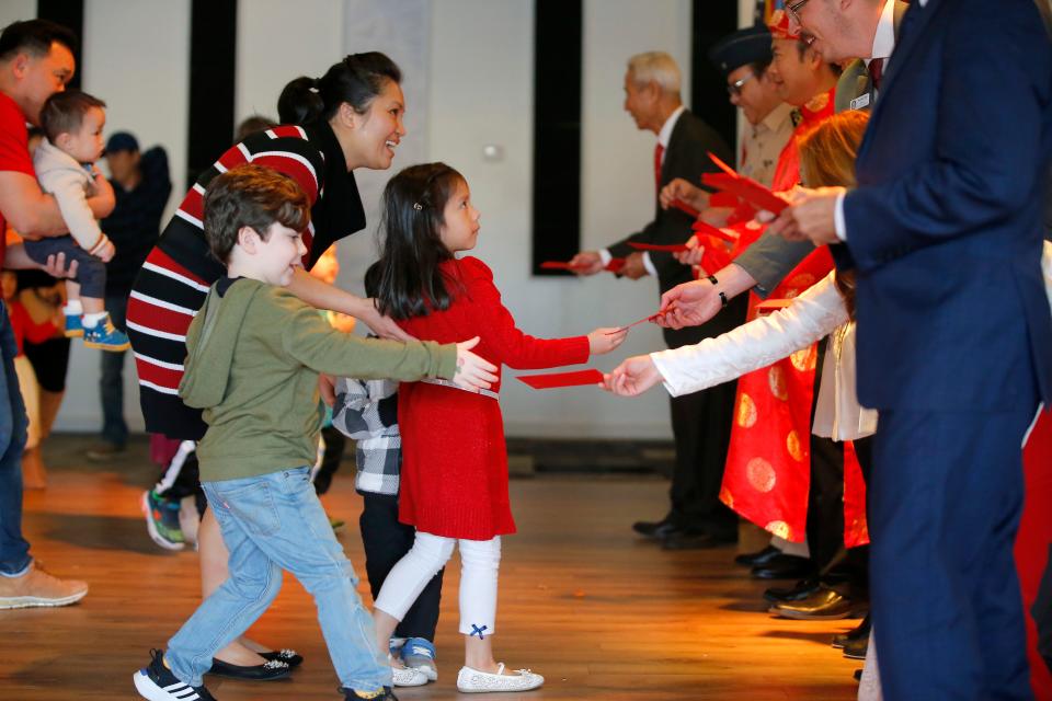 Children come forward to receive their Lucky Money during a Lunar New Year Celebration hosted by the Vietnamese American Community of Oklahoma at the Dove Event Center in Oklahoma City, Saturday, Jan. 14, 2023.