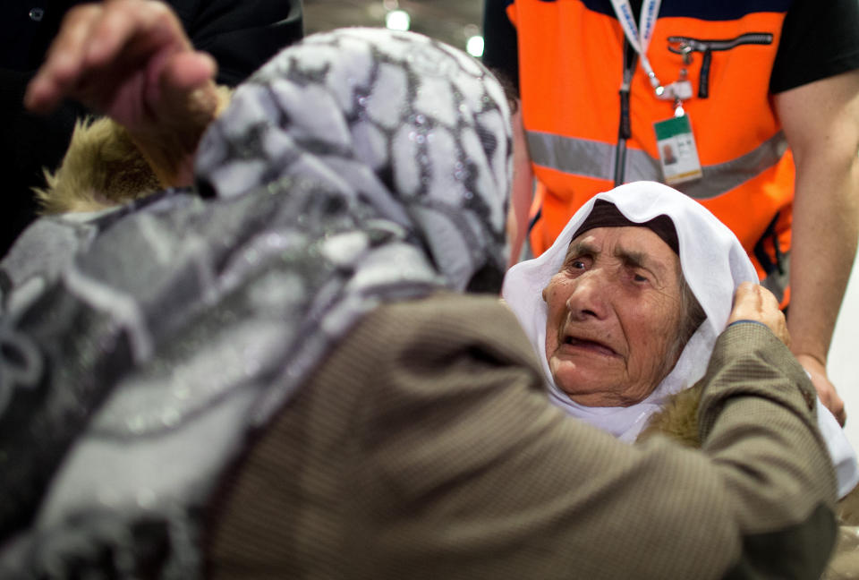 107-year-old Syrian Sabria Khalaf, right, is greeted by a family member as she arrives at the airport in Duesseldorf, Germany, Monday, March 17, 2014. The woman who fled the conflict in Syria has been reunited with her family in Germany. German officials say Khalaf arrived from Greece where she had originally applied for asylum. (AP Photo/dpa, Federico Gambarini)