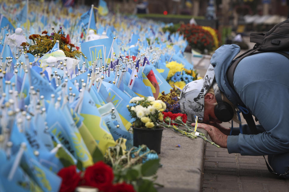 A woman reacts during the All-National minute of silence in commemoration of Ukrainian soldiers killed in the country's war against Russia on Independence square in Kyiv, Ukraine, Sunday, Oct. 1, 2023. Ukraine commemorates veterans and fallen soldiers on Sunday. The date of the annual Day of the Defenders was moved from 14th October as part of the reforms of the church calendar introduced by President Volodymyr Zelenskyy. (AP Photo/Alex Babenko)