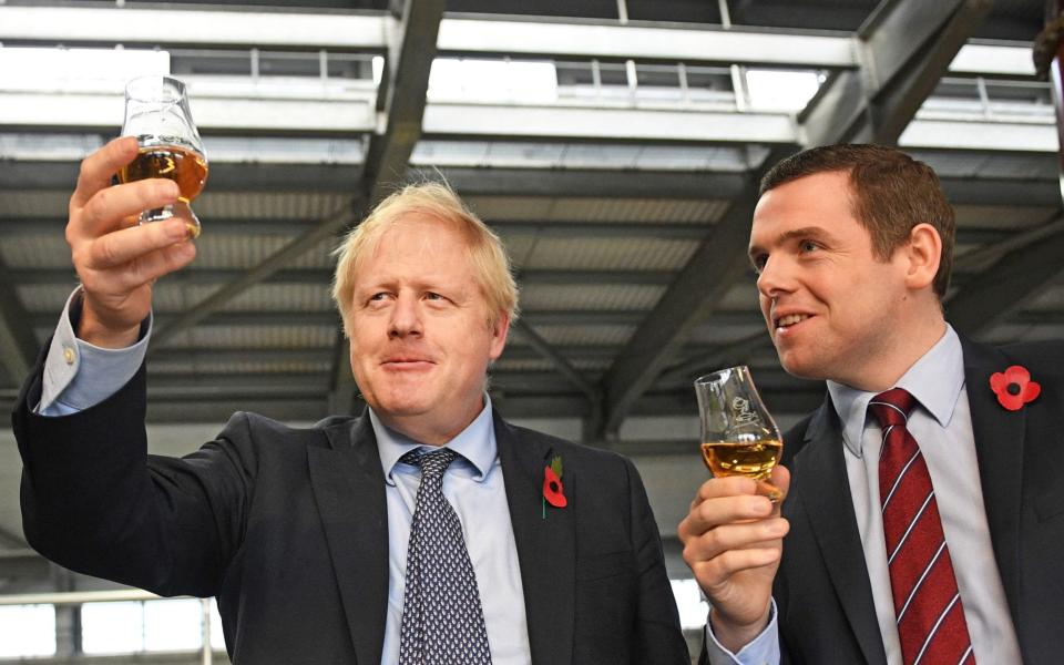 Prime Minister Boris Johnson (left) alongside Douglas Ross at a Moray distillery - PA