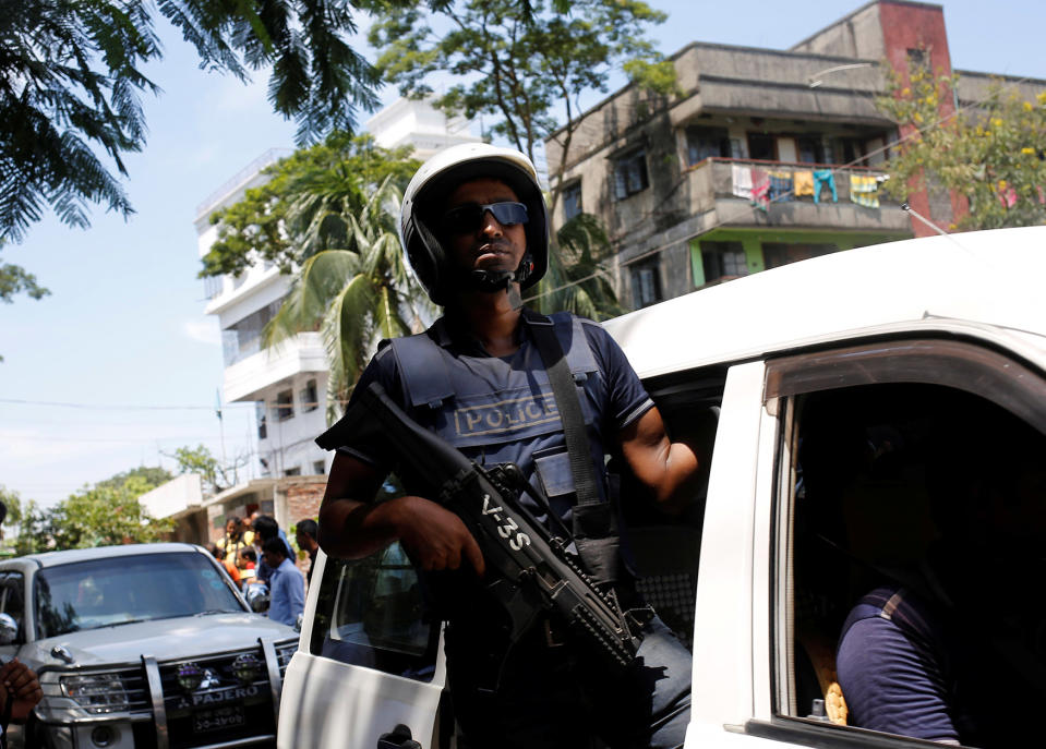 <p>A member of the security personnel stands on the side of a car as he arrives at the site of a gunbattle with militants on the outskirts of Dhaka, Bangladesh, August 27, 2016. (REUTERS/Mohammad Ponir Hossain) </p>