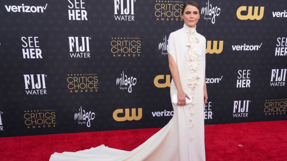 Keri Russell, who stars in “The Diplomat,” wore a sleek Stéphane Rolland number with a high collar and ruffles. She accessorized with diamond and petrified wood jewelry from Fernando George. - Jordan Strauss/Invision/AP