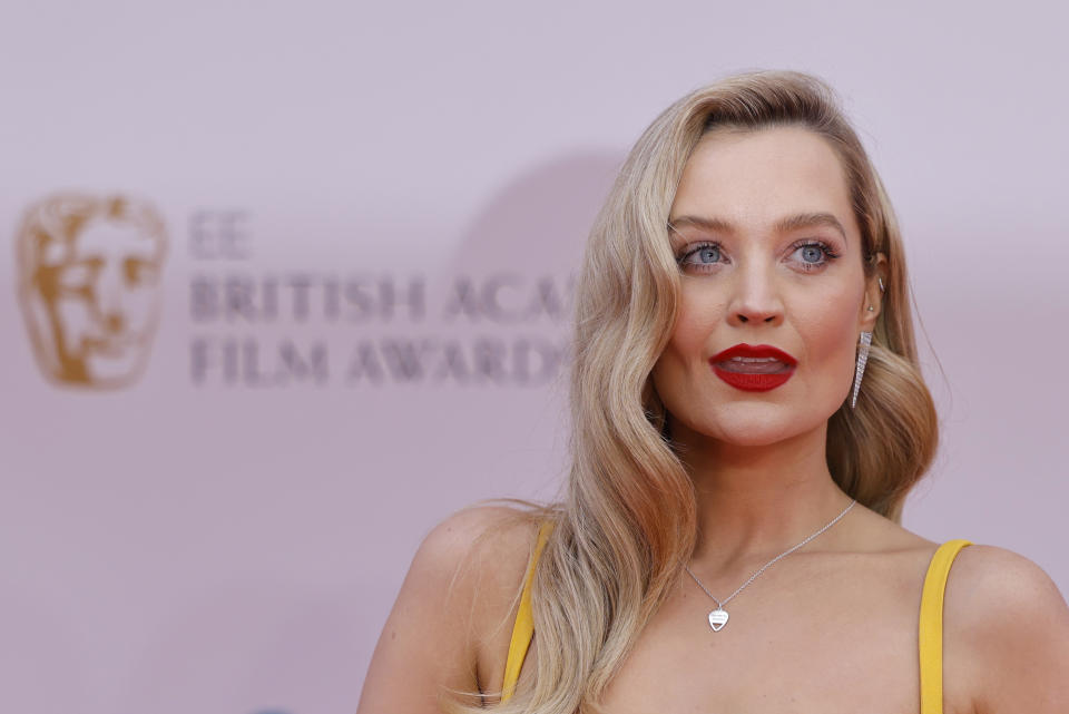 Irish model Laura Whitmore poses on the red carpet upon arrival at the BAFTA British Academy Film Awards at the Royal Albert Hall, in London, on March 13, 2022. (Photo by Tolga Akmen / AFP) (Photo by TOLGA AKMEN/AFP via Getty Images)