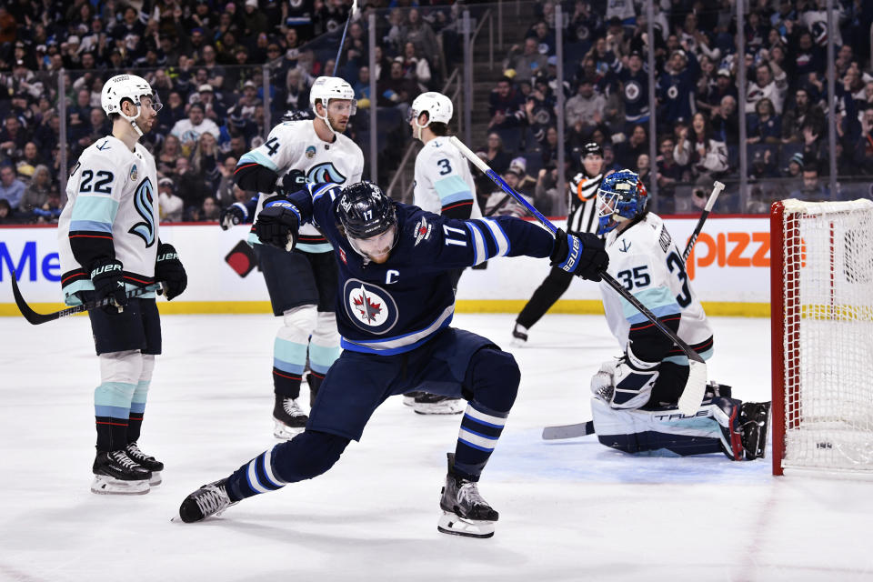 Winnipeg Jets' Adam Lowry (17) celebrates his goal on Seattle Kraken goaltender Joey Daccord (35) during the second period of an NHL hockey game Tuesday, March 5, 2024, in Winnipeg, Manitoba. (Fred Greenslade/The Canadian Press via AP)