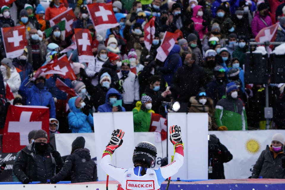 Switzerland's Wendy Holdener salutes supporters in the finish area of an alpine ski, women's World Cup super-G in St. Moritz, Switzerland, Saturday, Dec. 11, 2021. (AP Photo/Pier Marco Tacca)