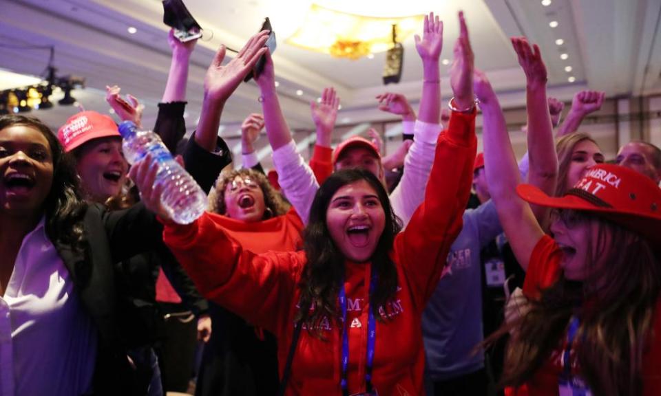 People celebrate after listening to Trump address the Conservative Political Action Conference in the Hyatt Regency in Orlando, Florida. Begun in 1974, CPAC brings together conservative organizations, activists, and world leaders to discuss issues important to them.