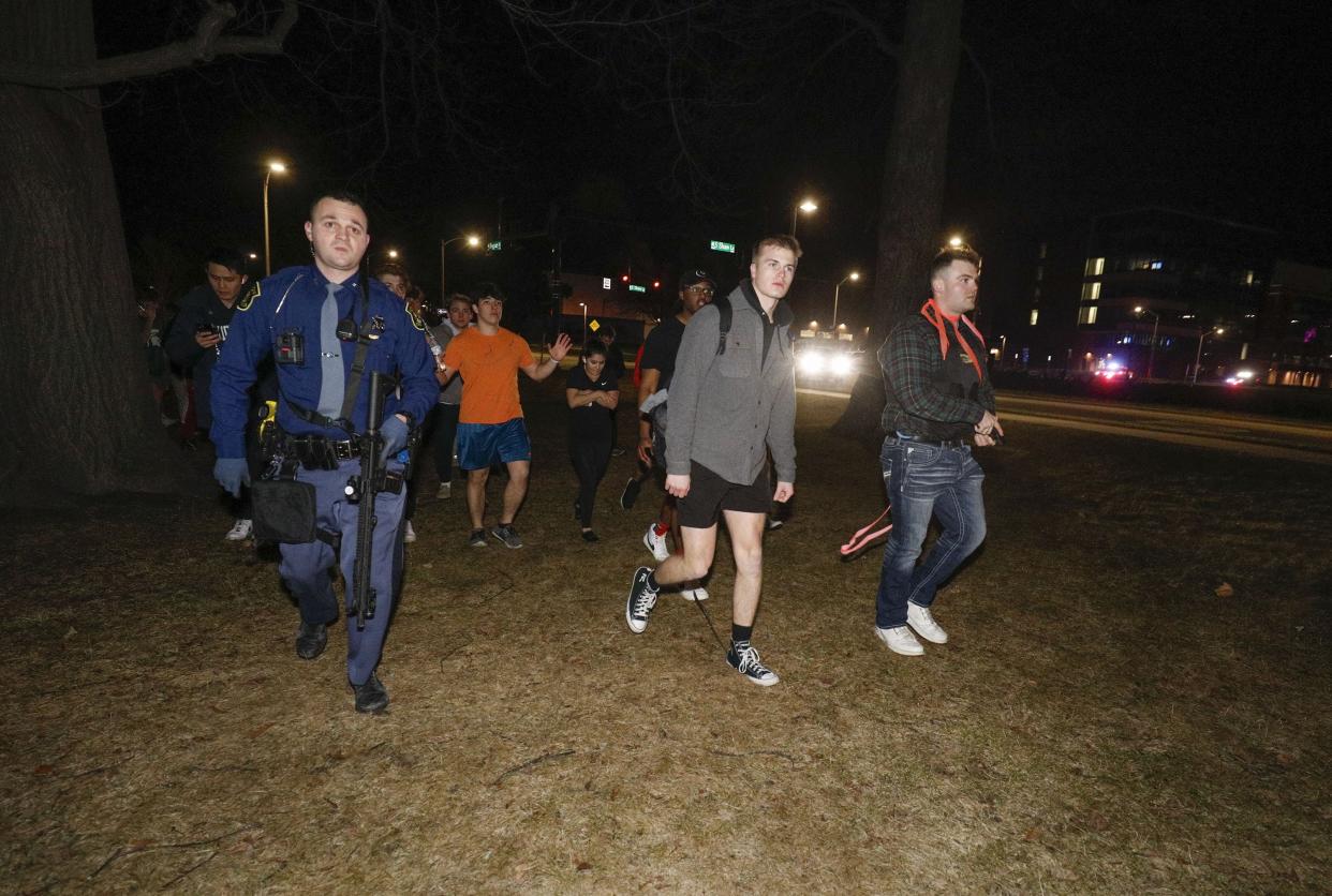 Michigan State University students are led to a safe area Feb. 13 in Lansing. In the wake of the Michigan State shooting, the University of Akron is reiterating safety protocols.