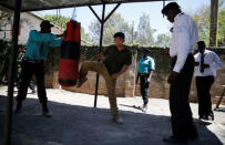 Chinese national Jack Wang (C) a security trainer at the Chinese-run Deway Security Group leads a Kenyan security guard in a physical exercise during martial arts combat training at their company compound in Kenya's capital Nairobi, March 13, 2017. REUTERS/Thomas Mukoya