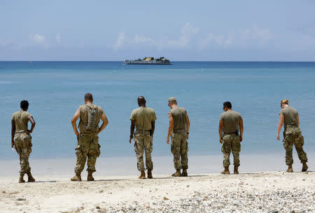 Soldiers from the 602nd Area Support Medical Company wait on a beach for a Navy landing craft as their unit evacuates in advance of Hurricane Maria, in Charlotte Amalie, St. Thomas, U.S. Virgin Islands September 17, 2017. REUTERS/Jonathan Drake