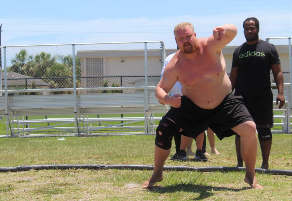 Mark Jones, who will compete in a sumo tournament in Japan Oct. 8, trains at Derbyshire Park in Daytona Beach. Another sumo wrestler, Cornelius Booker, stands to his right.