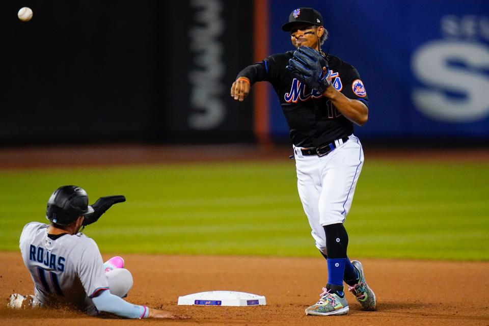 New York Mets' Francisco Lindor, right, throws out Miami Marlins' Jacob Stallings at first base after forcing out Miguel Rojas, left, for a double play during the seventh inning of a baseball game Friday, July 8, 2022, in New York. (AP Photo/Frank Franklin II)