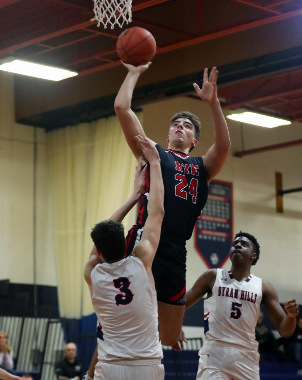 Rye's Jake Kessner (24) puts up as hot in front of Byram Hills Ben Wolf (3) during boys basketball action at Byram Hills High School in Armonk Jan. 26, 2024. Byram Hills won the game 66-53.