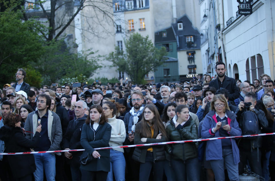 Tourists and Parisians looked on aghast from the streets below as they watch flames and smoke rise from the Notre Dame cathedral fire. Source: AP Photo/Michel Euler