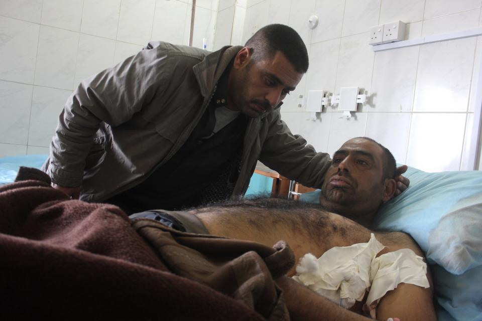 A man who was wounded in a bomb attack lies at a hospital in Baquba