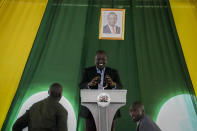 Kenya's President-elect William Ruto, stands under a photograph of current president Uhuru Kenyatta, as he prepares to address the media at his official residence of the deputy president in the Karen area of Nairobi, Kenya Wednesday, Aug. 17, 2022. (AP Photo/Mosa'ab Elshamy)