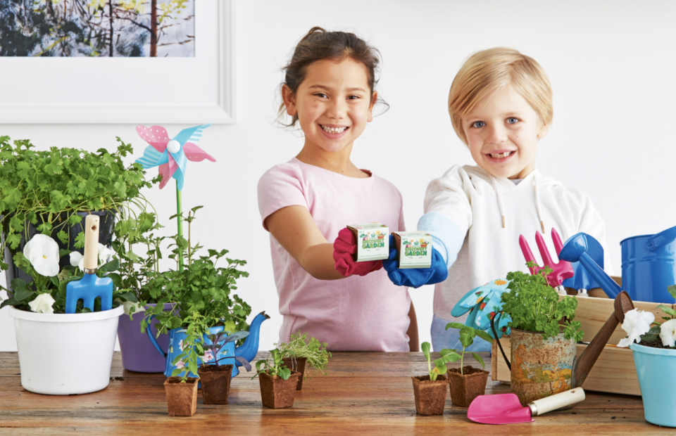 A Woolworths promotion photo showing children can learn how to plant seeds as part of the Discovery Garden supermarket collectables campaign. 